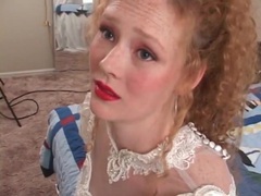 KiloTube presents: Redhead in wedding dress models her pussy